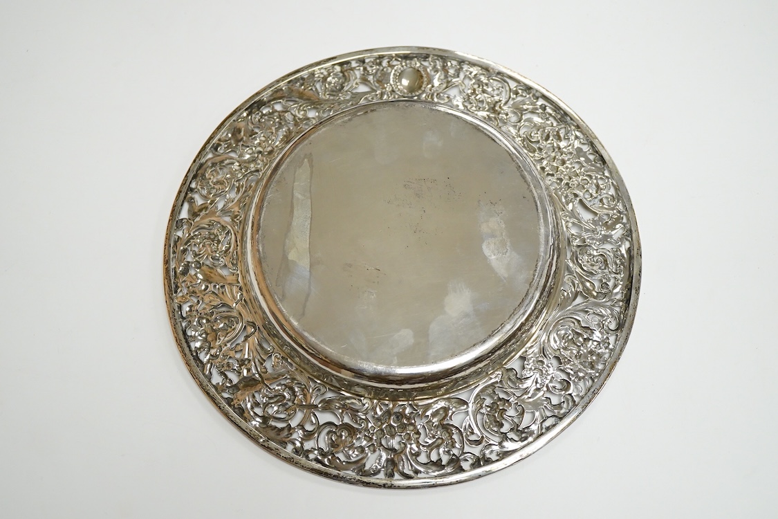 A late Victorian shallow dish or stand, by William Comyns, with pierced foliate border, decorated with masks and birds, London, 1898, diameter 23.1cm, 11.4oz.